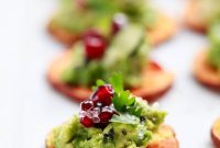 Vibrant Sweet Potato Crostini with Avocado, Pomegranate, and Caviar Lime Pearls