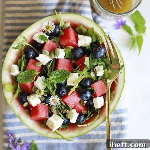Watermelon, feta, arugula, and mint salad, artfully arranged and ready to be served