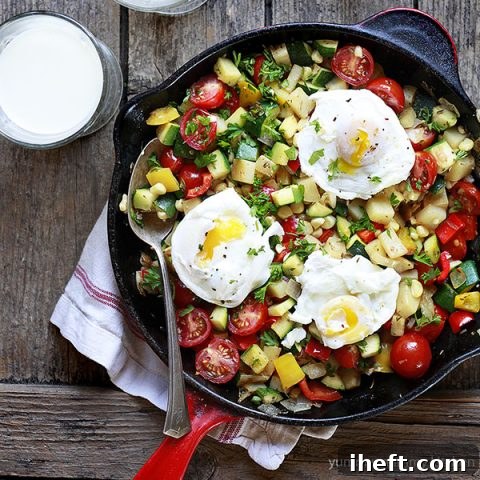 Vibrant veggie hash in a red skillet, ready to serve.