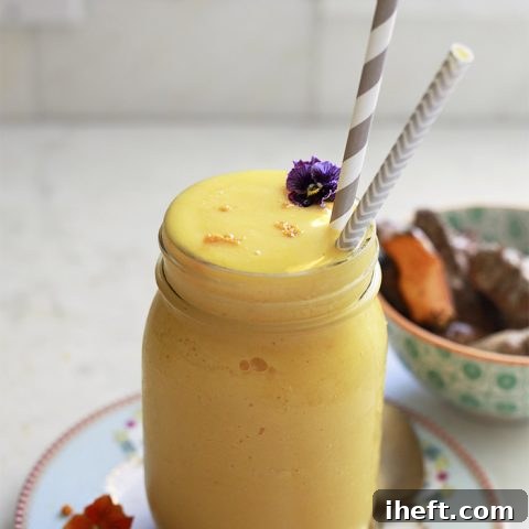 Bright orange tropical turmeric smoothie recipe.