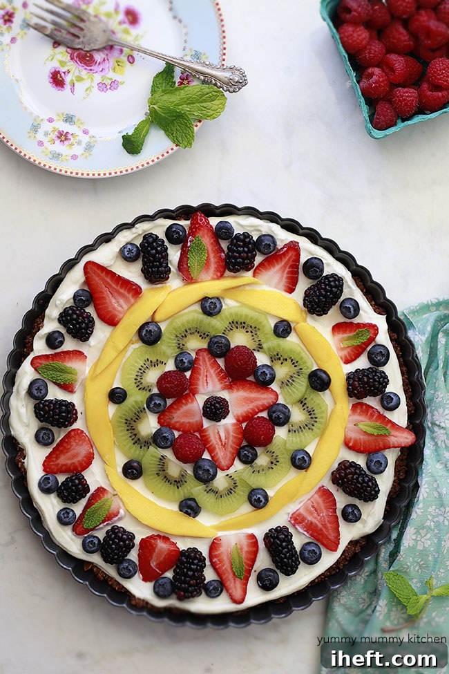 Healthy fruit and granola tart decorated with assorted fresh fruits.