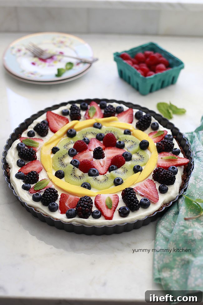 Breakfast fruit and granola tart ready to be served, showcasing vibrant colors and fresh ingredients.