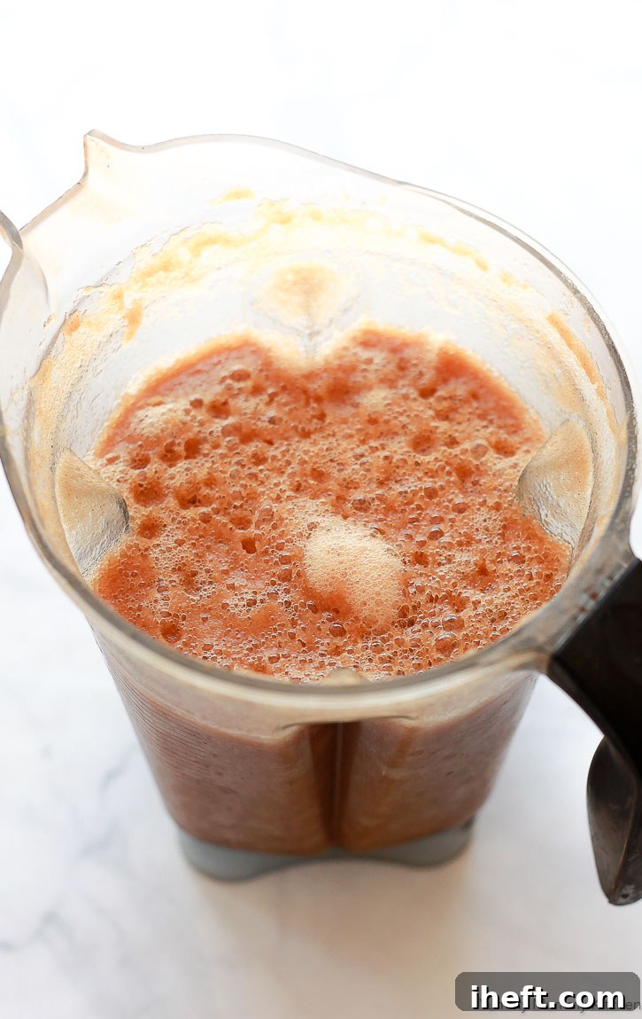 Blend fresh apple chunks with a little water to create apple juice using a high-speed blender, a simple juicer alternative.