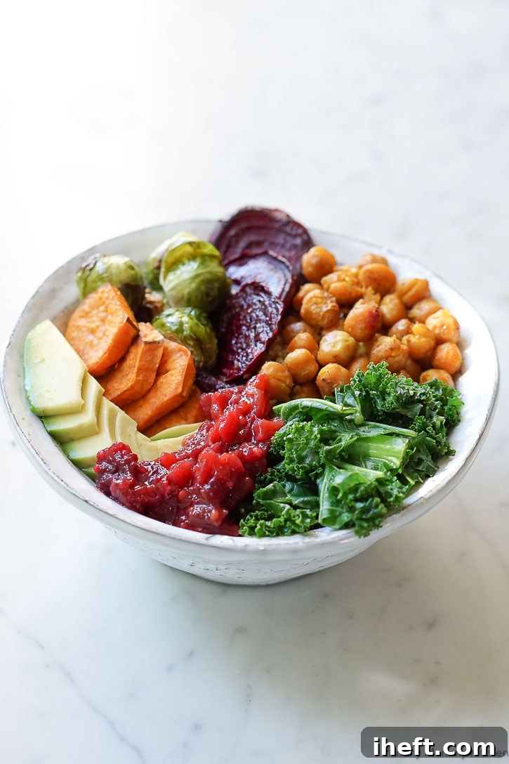 Curry roasted chickpeas and mixed vegetables create a delectable autumn Buddha Bowl, perfectly complemented by a dollop of tangy cranberry chutney.