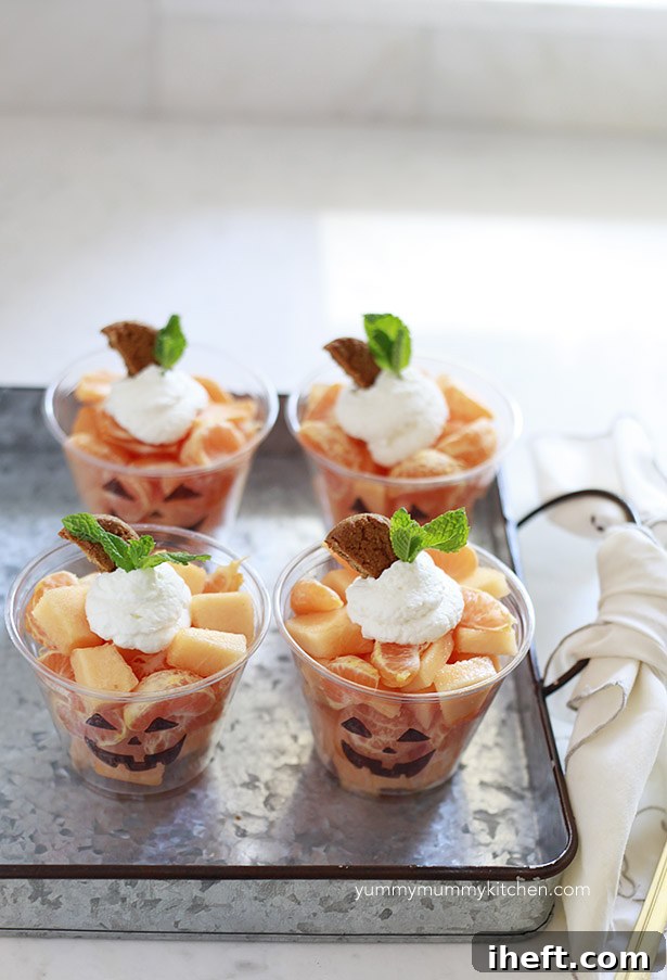 Ingredients for Jack-o'-lantern fruit cups: tangerines, cantaloupe, mint, and gingersnaps