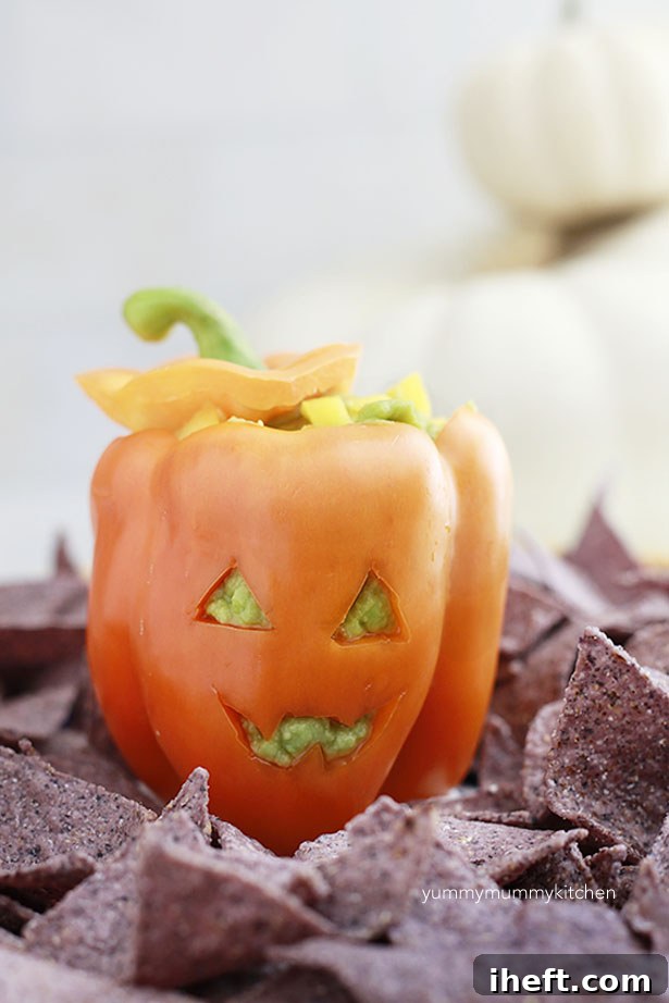 Healthy Halloween Appetizer: Bell Pepper Jack-o'-Lantern filled with Guacamole