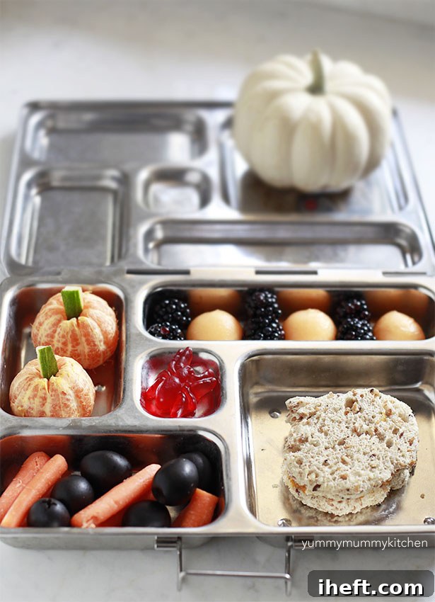 Close-up of a festive Halloween-themed bento box lunch featuring creative food art