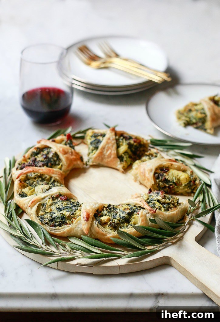 Beautiful Spinach Artichoke Puff Pastry Wreath on a wooden board