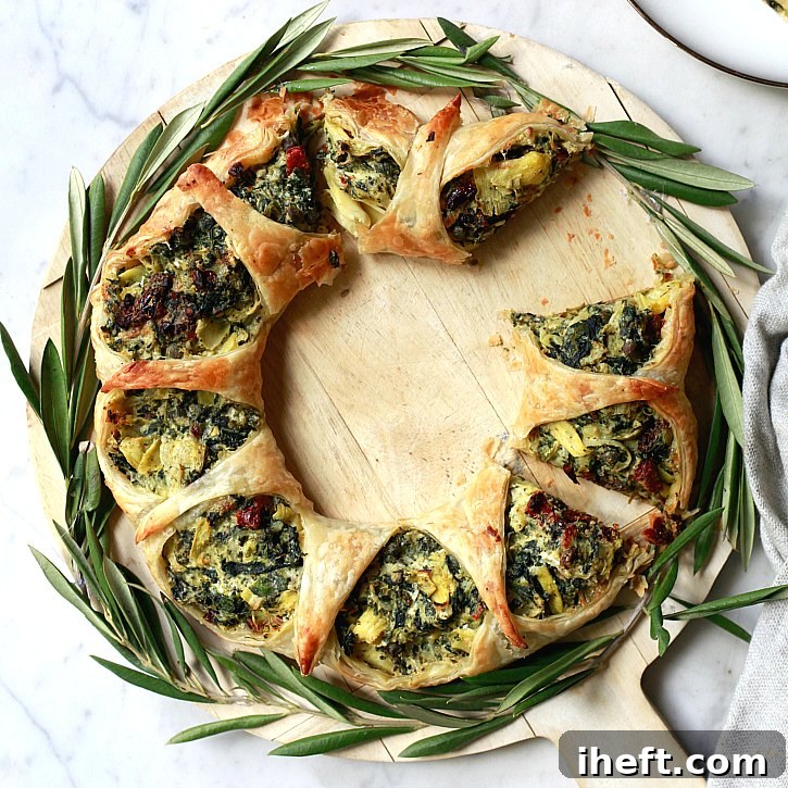 A slice of Spinach Artichoke Puff Pastry Wreath showing the filling