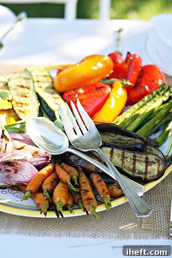 A vibrant and artfully arranged platter showcasing an assortment of perfectly grilled summer vegetables, including zucchini, eggplant, and bell peppers, ready to be served.
