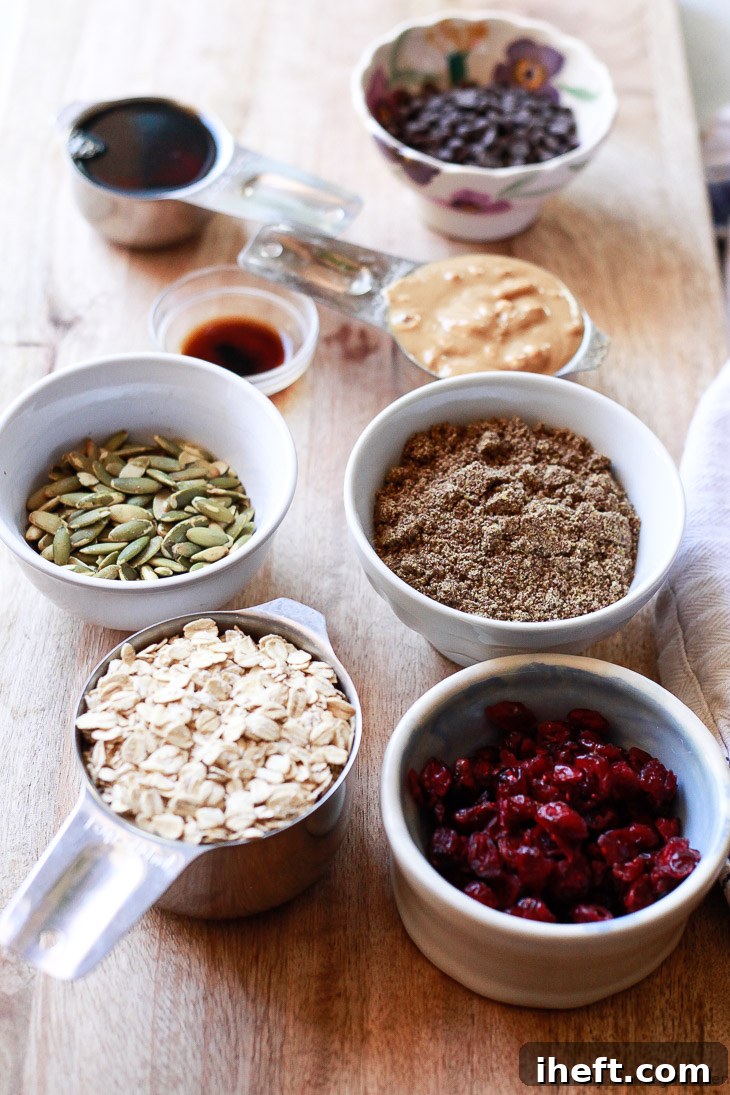 Healthy ingredients like gluten-free oats, flax meal, pepitas (pumpkin seeds), and cranberries, perfectly portioned and ready to be transformed into nourishing no-bake energy bars.