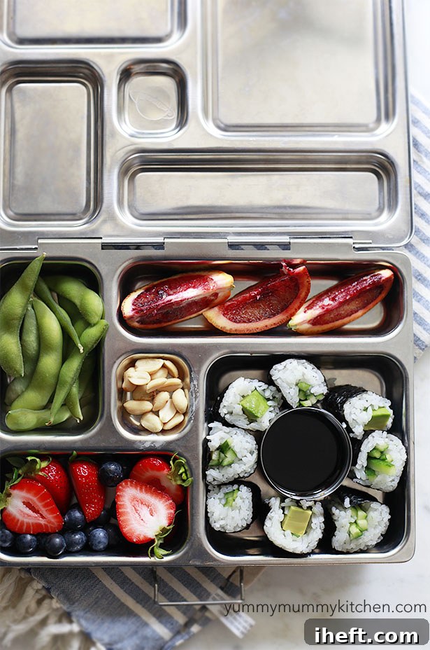 A healthy vegetarian and vegan kids' lunch in a planetbox with sushi, fruit, and vegetables.