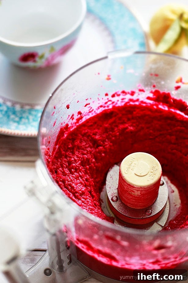 Bright red beet hummus just blended in a food processor.