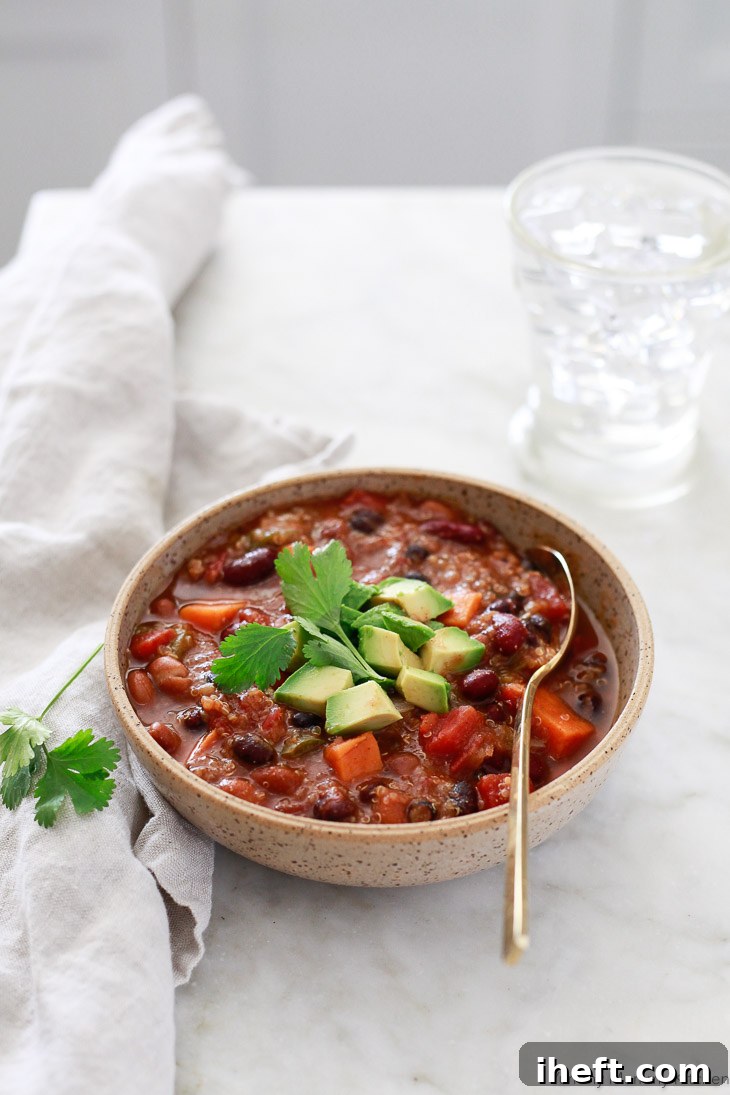 A delicious bowl of vegetarian and vegan chili made with a delightful mix of beans, quinoa, and sweet potato. This chili was made effortlessly in the Instant Pot.