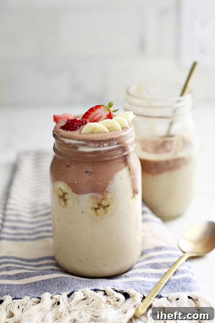 A rich peanut butter banana smoothie topped with banana slices.