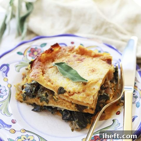 A beautiful slice of pumpkin and chard lasagna topped with a sage leaf.