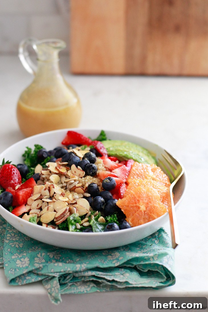Sweet and tangy fresh orange vinaigrette generously coats a healthy superfood salad, featuring tender kale, fluffy quinoa, mixed berries, and succulent orange segments. This makes for an ideal vegan and vegetarian lunch idea, bursting with flavor and nutrients.