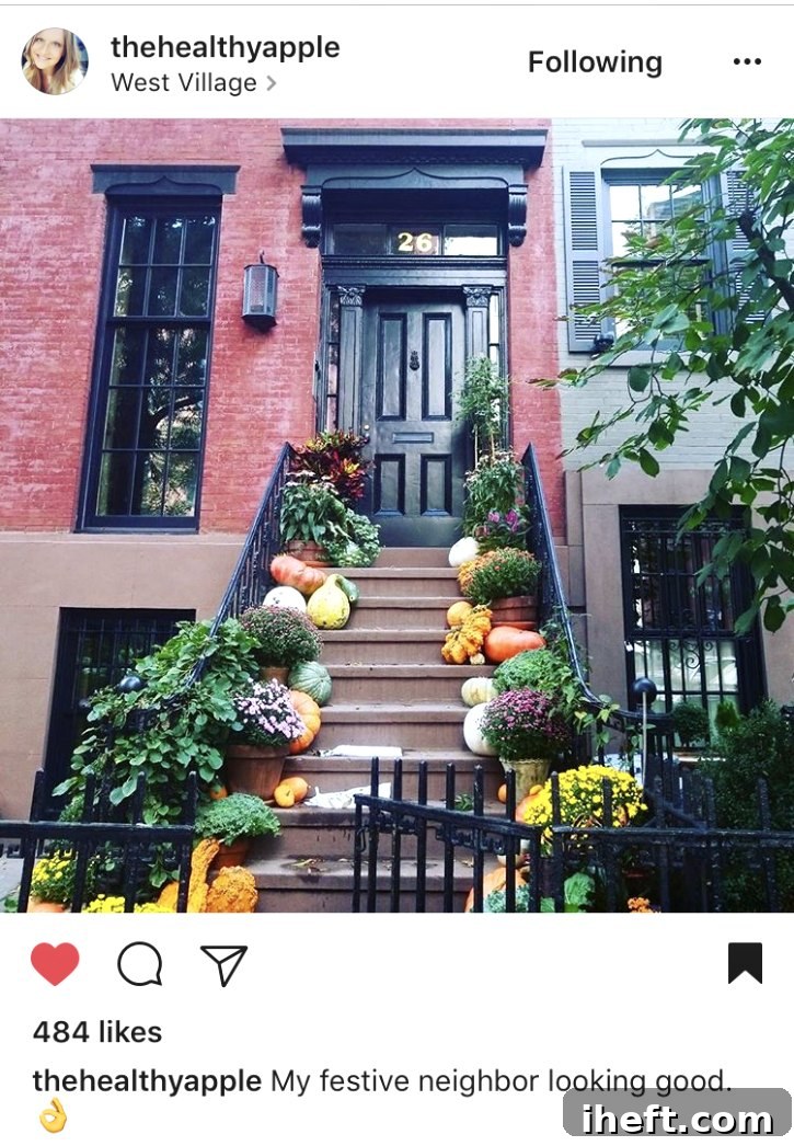 A beautiful and sophisticated fall front porch in New York City, featuring classic autumn elements.