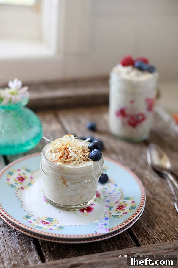 Overnight oatmeal jar made with almond milk and topped with coconut and blueberries. 