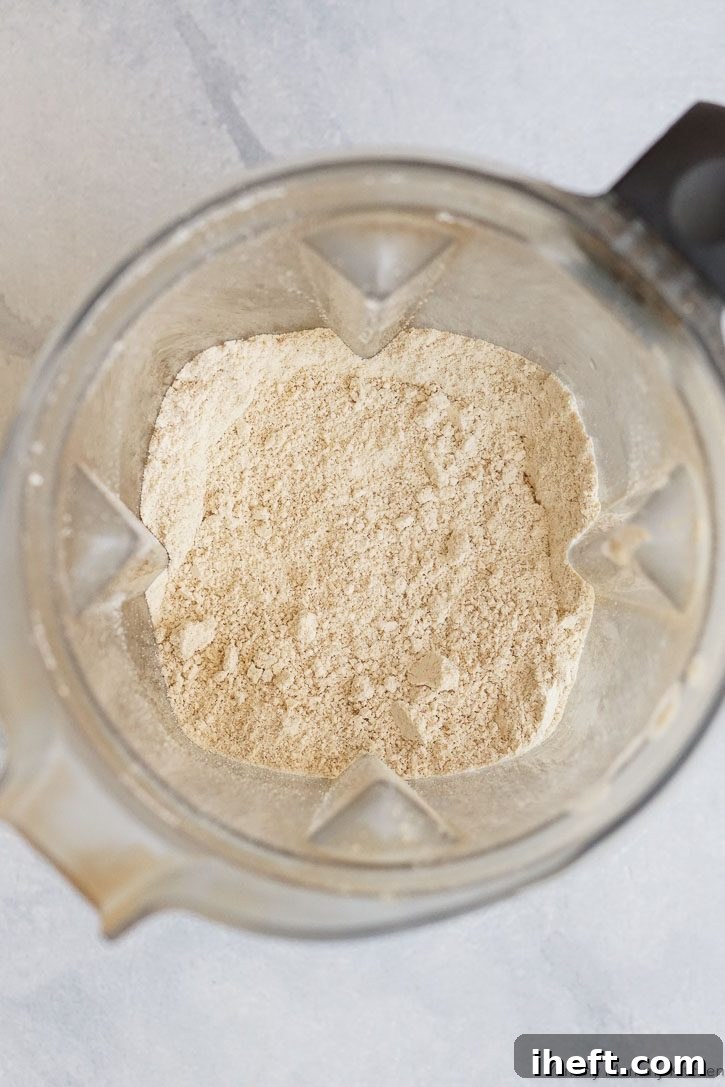 Freshly blended homemade oat flour in the bottom of a high-speed Vitamix blender container.