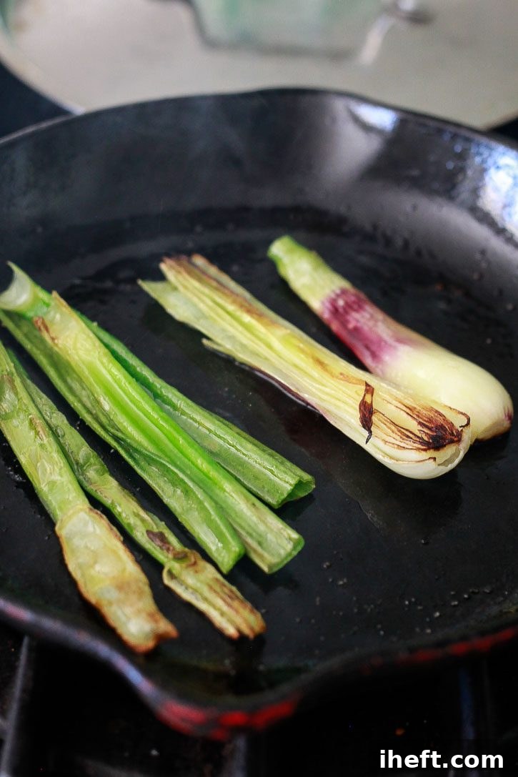 Spring onions get charred on a stovetop skillet.