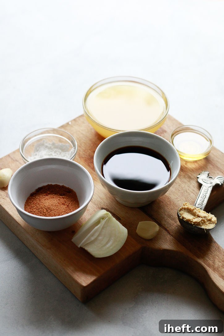A vibrant flat lay showcasing all the fresh, natural ingredients meticulously laid out on a rustic wooden cutting board, ready for making the best homemade teriyaki sauce. Key components include a fresh pineapple, knob of ginger, garlic cloves, a small yellow onion, and bottles of gluten-free soy sauce and toasted sesame oil.