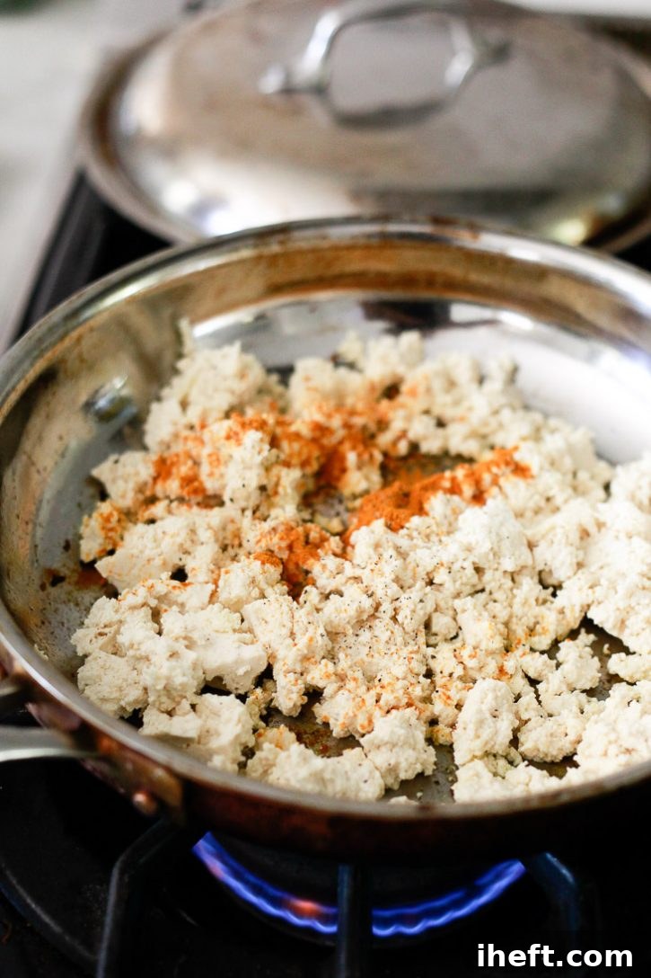 Tofu and turmeric cook into a tofu scramble for vegan breakfast burritos. 