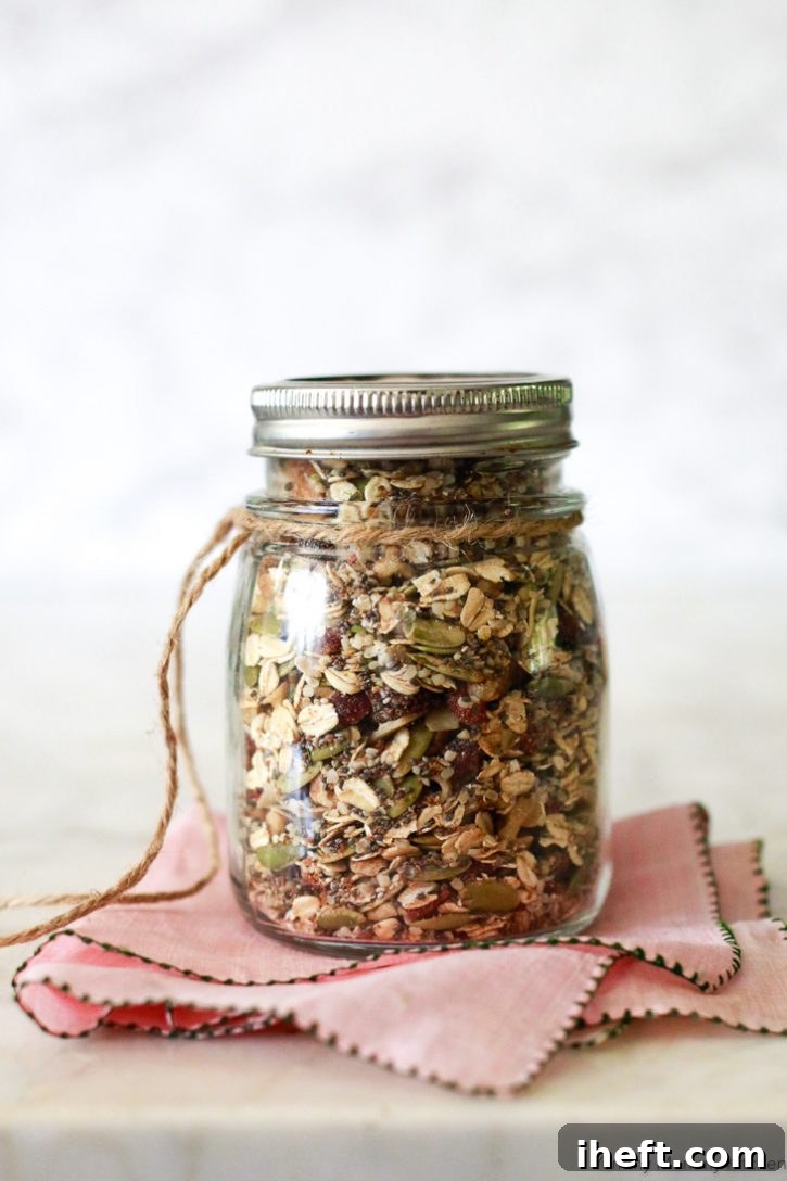 A jar of mixed Bircher muesli, prepared and ready to be soaked overnight, or enjoyed either hot or cold for a wholesome and healthy vegan breakfast.