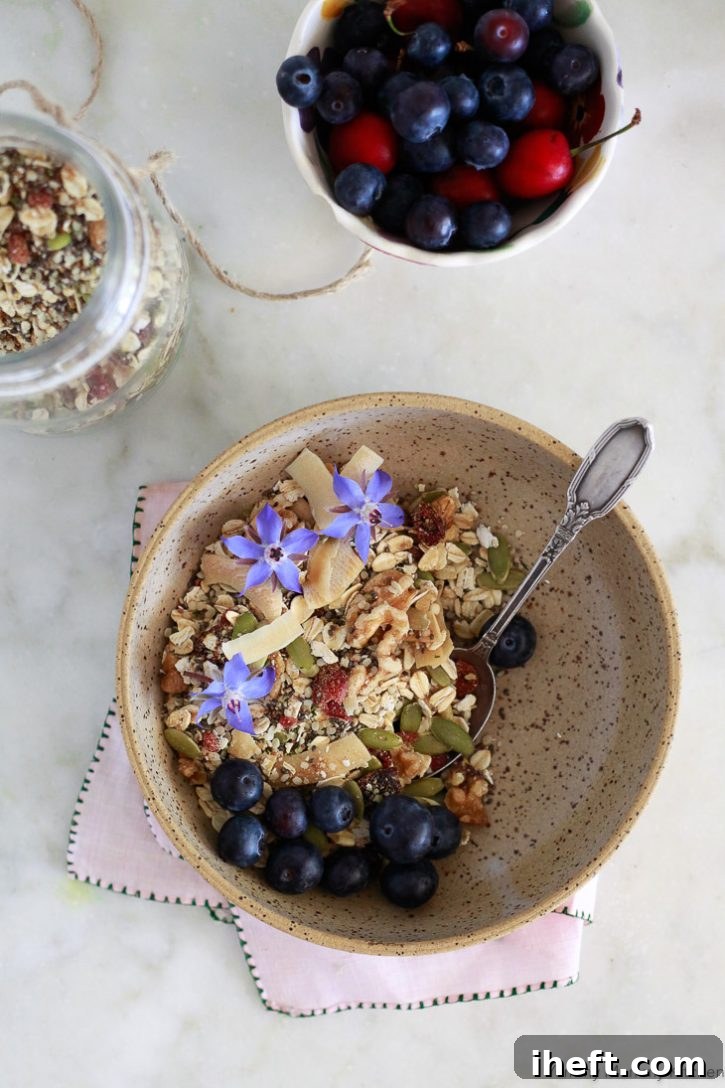 Bircher muesli served in a bowl, elegantly topped with fresh blueberries and delicate edible flowers, making it a beautiful and healthy breakfast.