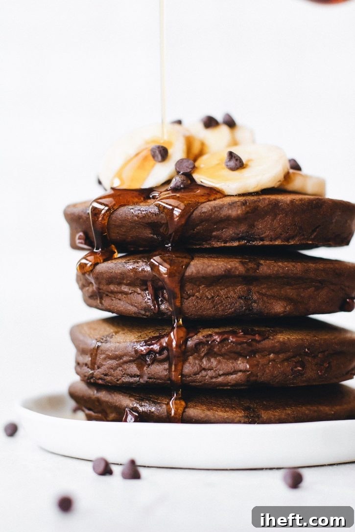 Decadent fluffy chocolate banana pancakes with chocolate chips, made with quinoa flour.