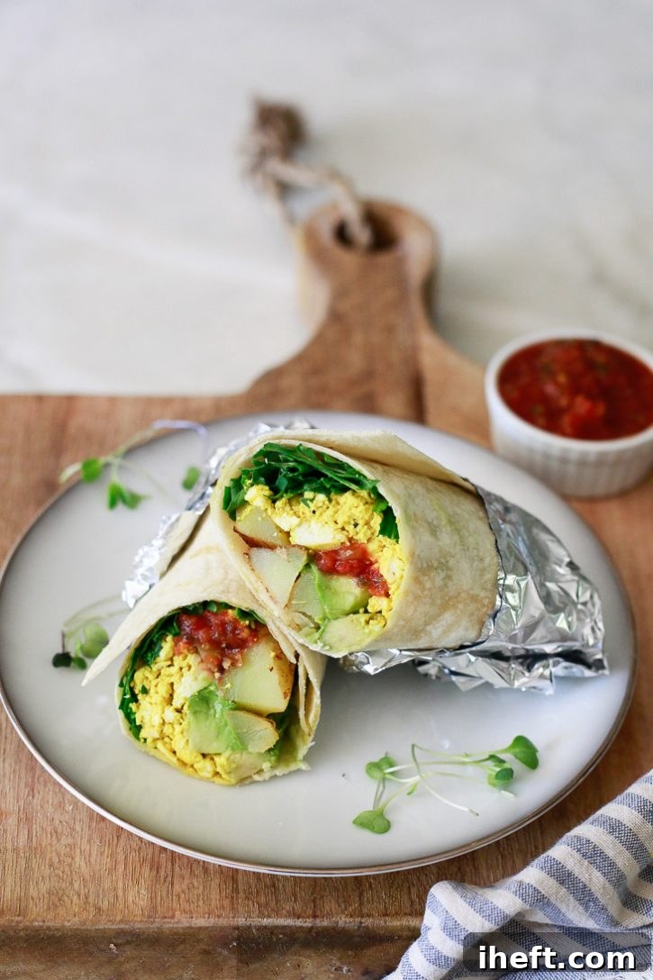 A delicious vegan breakfast burrito filled with tofu scramble, avocado, and salsa.