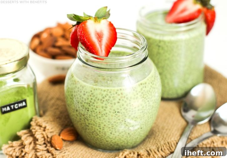 A vibrant green matcha chia pudding topped with a strawberry, an energizing and healthy vegan treat.