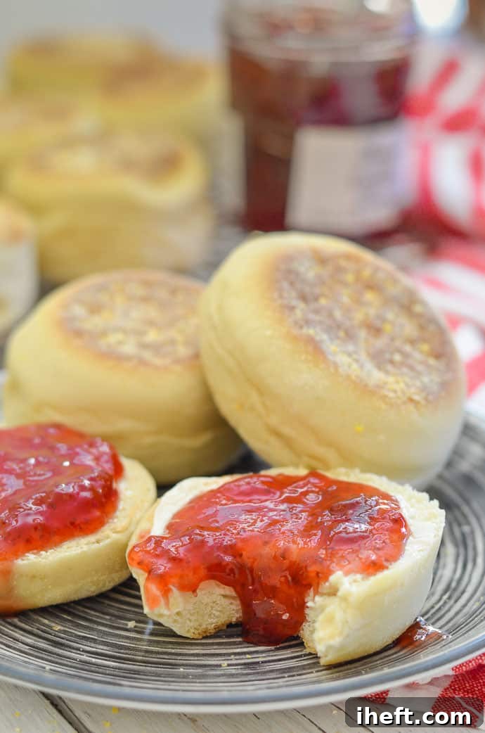 Light and fluffy homemade English muffins, golden brown and served with jam.