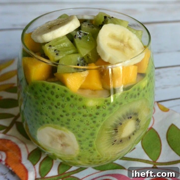 A bright green chia pudding, healthy and sugar-free, topped with fresh fruit.