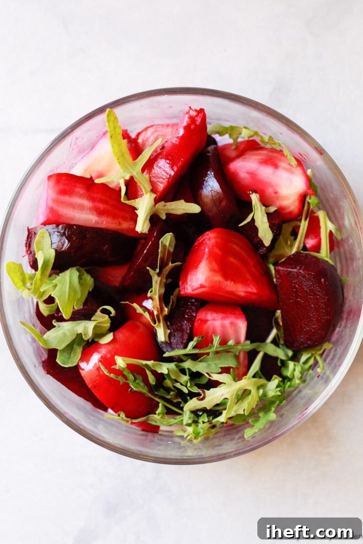 A simple yet elegant roasted beet salad, featuring tender beets paired with fresh arugula and a drizzle of balsamic vinegar.