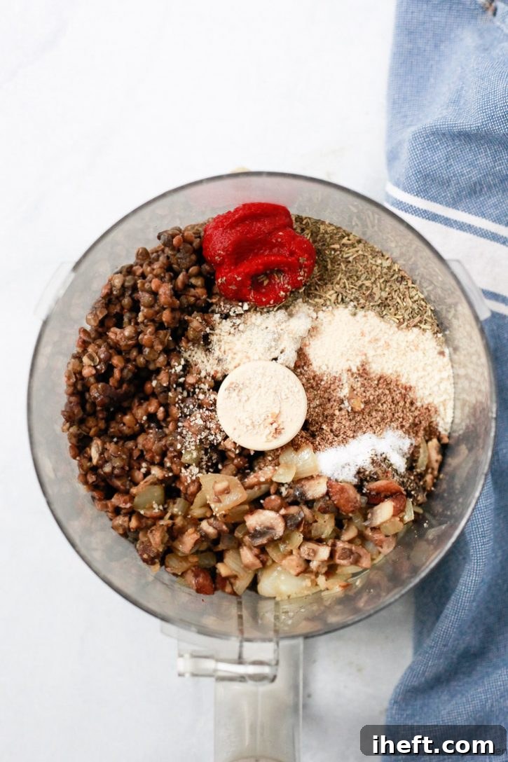 Lentils, mushrooms, walnuts, Italian spices, tomato paste, and bread crumbs in a food processor to make vegan lentil meatballs. 