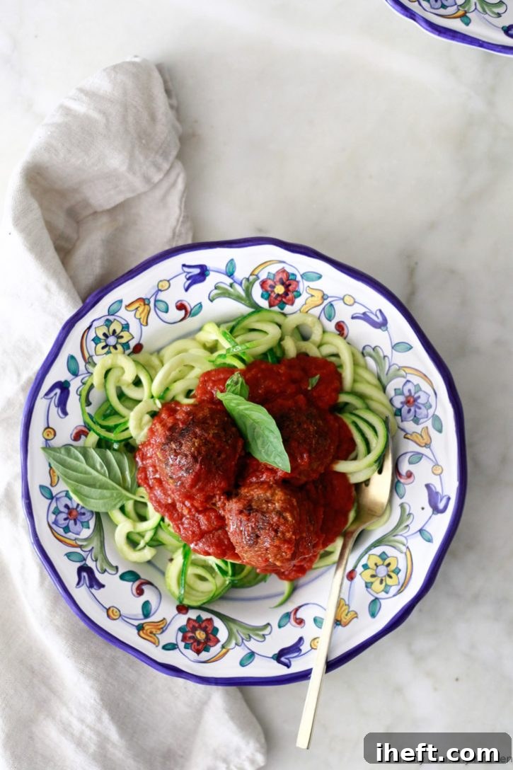 A plate of Italian vegan lentil meatballs with marinara sauce and zucchini noodles. These delicious meatless meatballs are vegan and gluten free. 