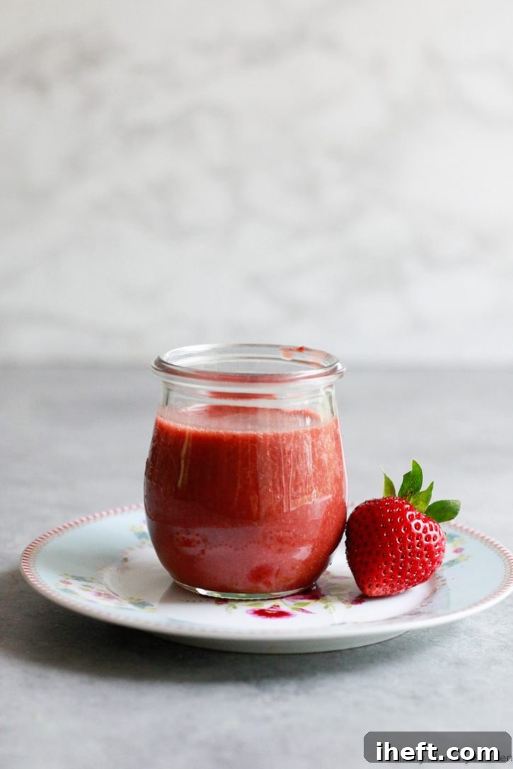 A charming Weck jar, perfectly showcasing the beautifully crafted homemade strawberry balsamic vinaigrette salad dressing, ready to be stored or served.