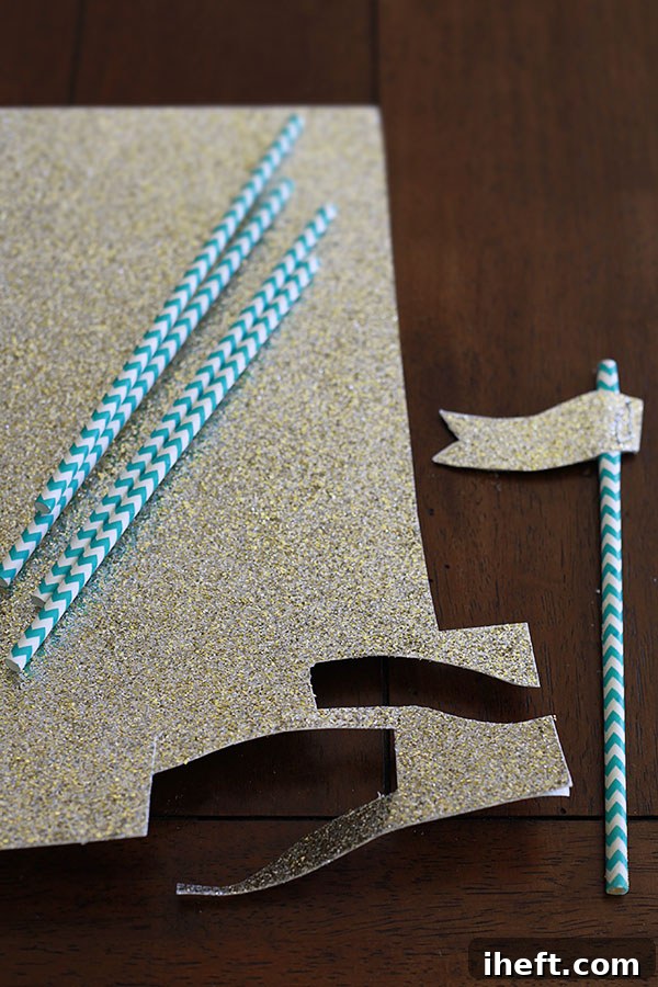 The process of coating the sandcastle cake with cookie crumbs, creating a realistic sandy texture.