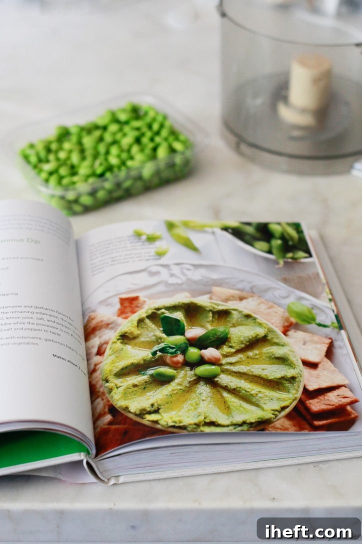 Edamame Hummus recipe from the Yummy Mummy Kitchen cookbook. Featuring a delightful spread on toast with cherry tomatoes.