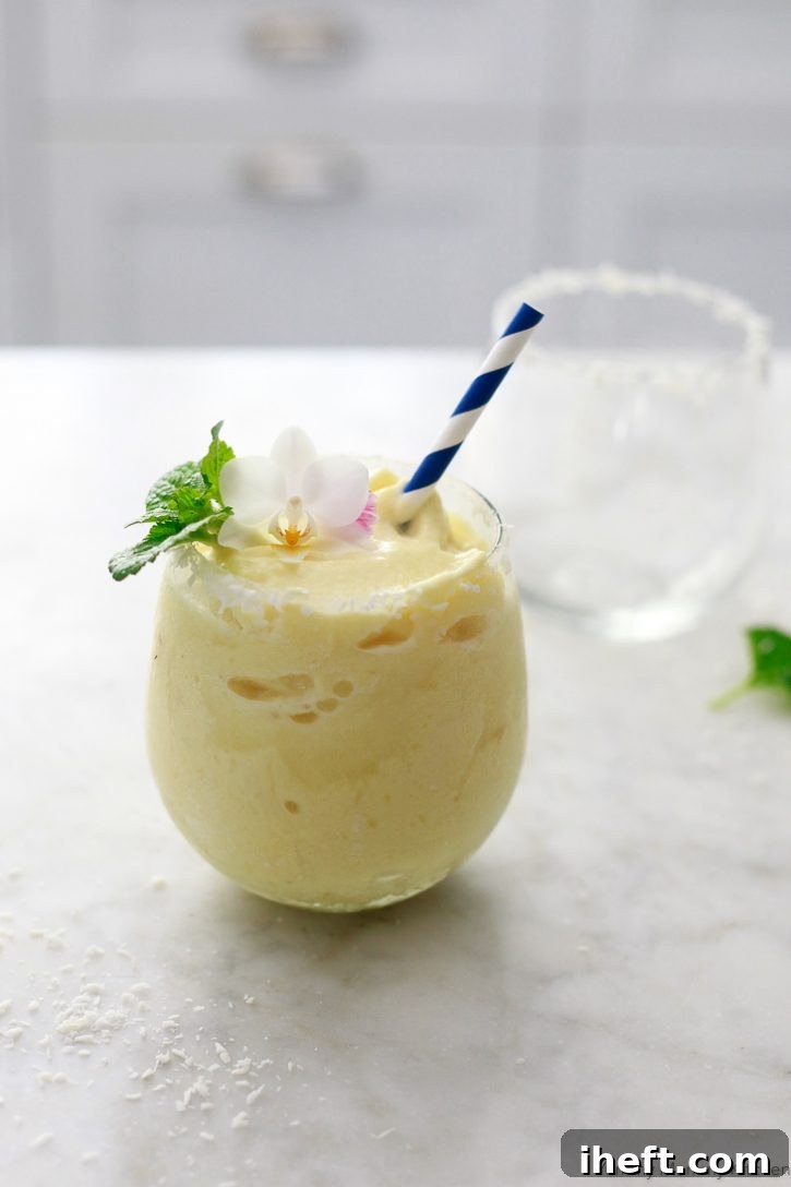 This virgin pina colada recipe is the best tropical smoothie! Made with coconut milk and frozen pineapple, it's a healthier vegan pina colada. 