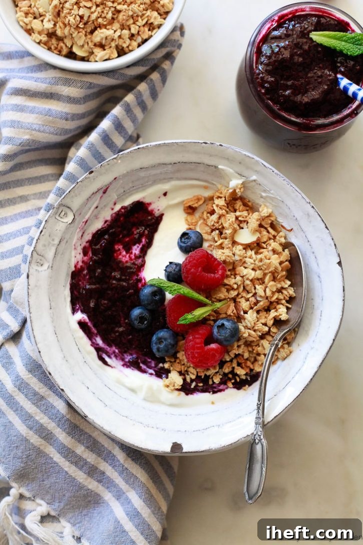 Overhead shot of two slices of toast topped with creamy peanut butter and two different kinds of homemade chia jam. One jam is a vibrant red raspberry, the other a deep purple blueberry, showcasing the versatility of this healthy recipe.