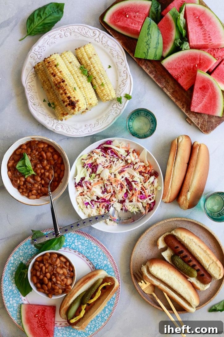 A vibrant and inviting photo showcasing a vegetarian summer BBQ spread. The table features delicious veggie dogs, hearty vegetarian baked beans, fresh vegan coleslaw, refreshing watermelon slices, and perfectly grilled corn on the cob.