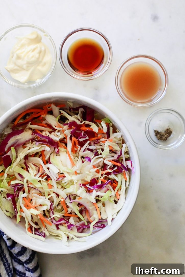 A bowl filled with shredded cabbage and carrots, accompanied by the essential ingredients needed to create an easy and creamy homemade vegan coleslaw.