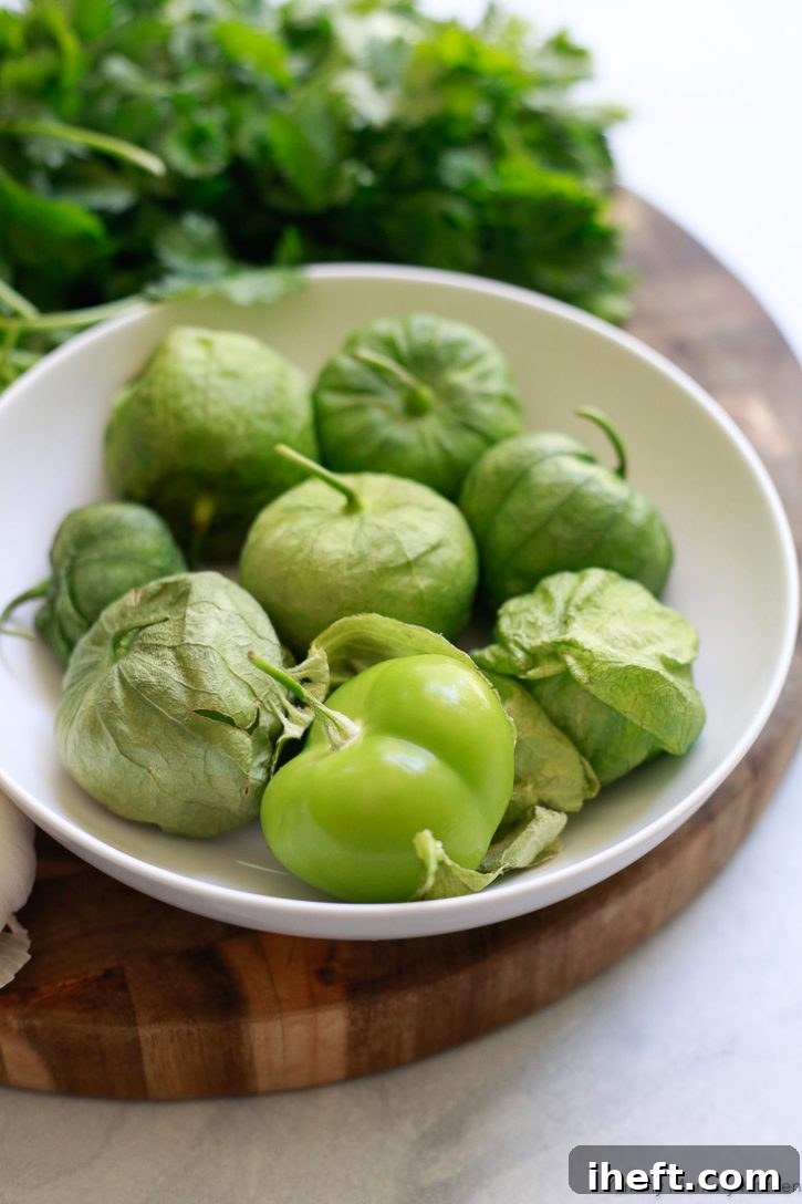 A bowl of fresh tomatillos in their husks are ready to be roasted for tomatillo salsa. 