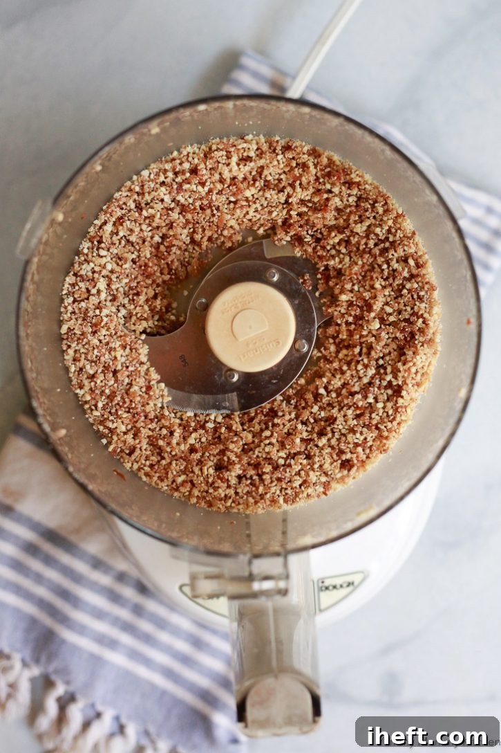The initial ingredients for no-bake cookies being skillfully blended in a food processor, creating a fine and consistent base for the healthy treats.
