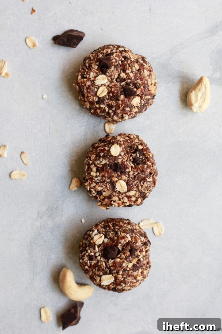 A close-up view of delectable vegan, gluten-free healthy no-bake oatmeal cookies, prominently featuring their wholesome ingredients of cashews, oats, and dates, ready to be enjoyed.