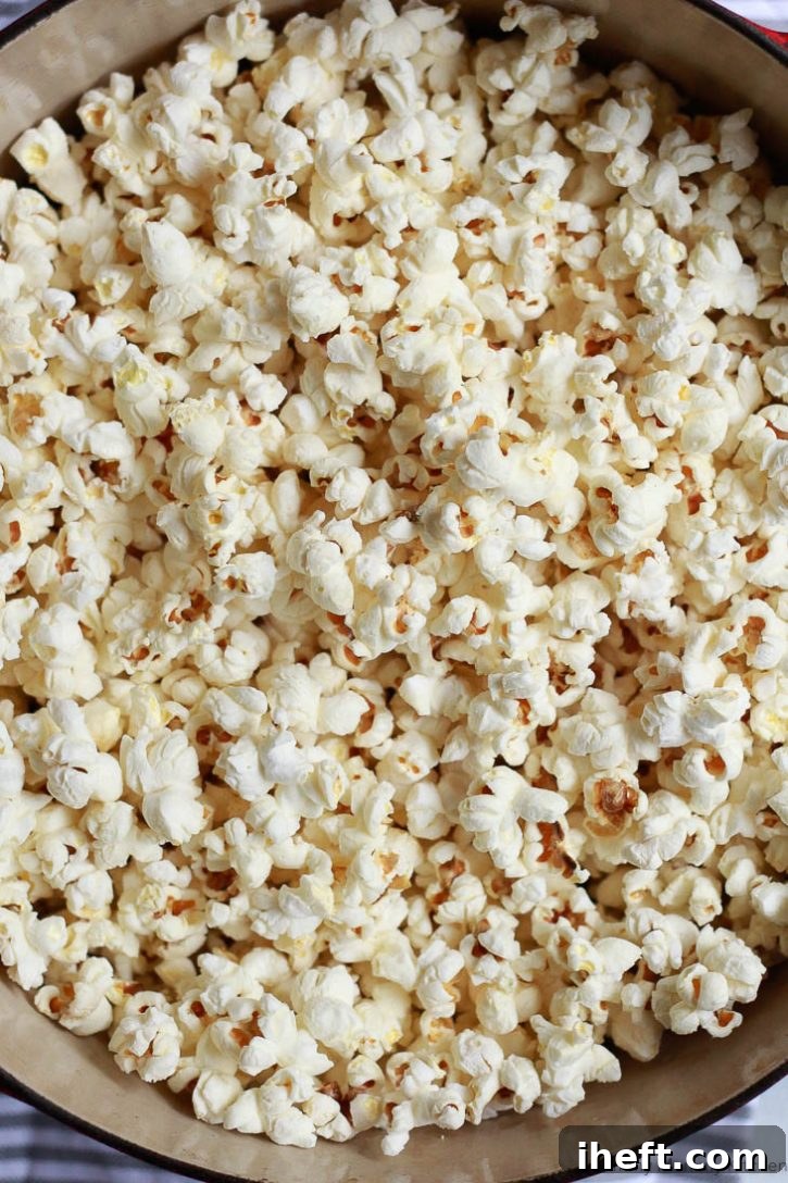 A mountain of freshly popped homemade stovetop popcorn, light and fluffy, ready for your favorite seasonings.