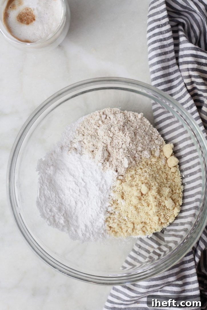 Oat flour, almond flour, and tapioca flour in a bowl to make gluten free pumpkin muffins. 