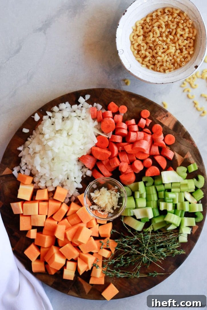 A beautifully arranged collection of fresh ingredients for Instant Pot Minestrone Soup on a rustic cutting board, showcasing vibrant vegetables, beans, and herbs.